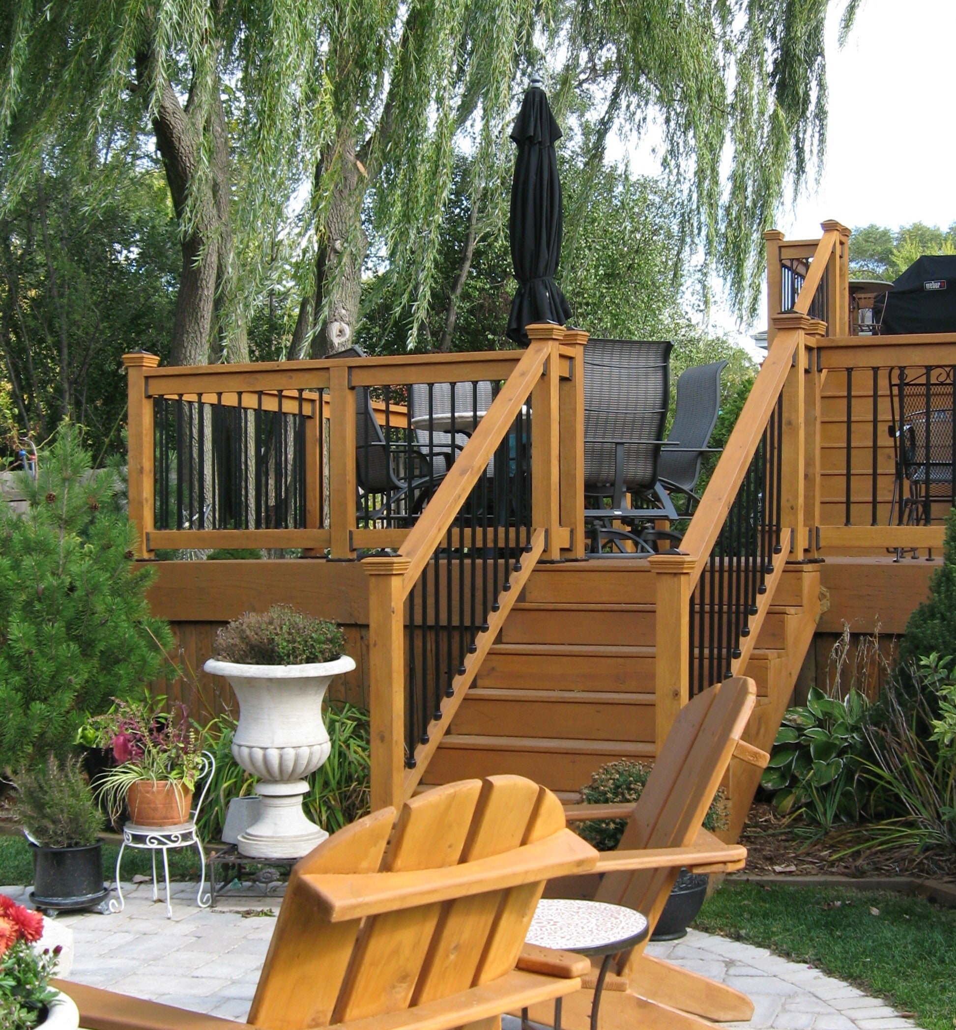 Wooden deck with chairs and plants in a garden setting