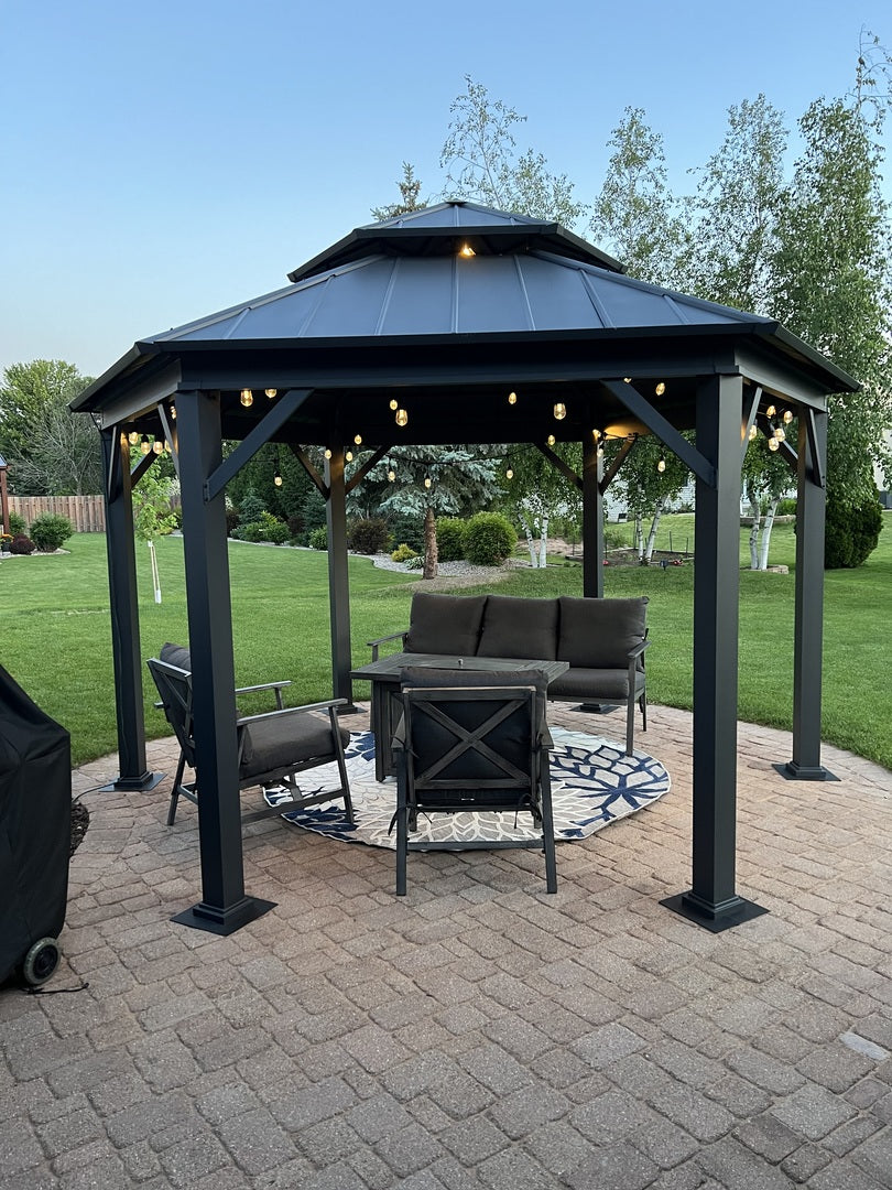 Hexagonal gazebo with outdoor furniture on a paved patio