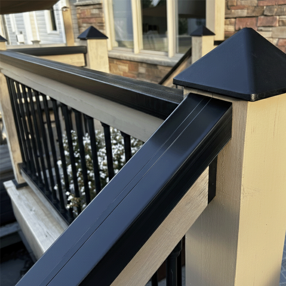 Railing with black pyramid-shaped balusters on a wooden deck
